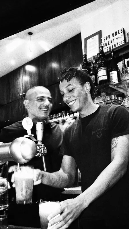Barmen du Progrès derrière le comptoir